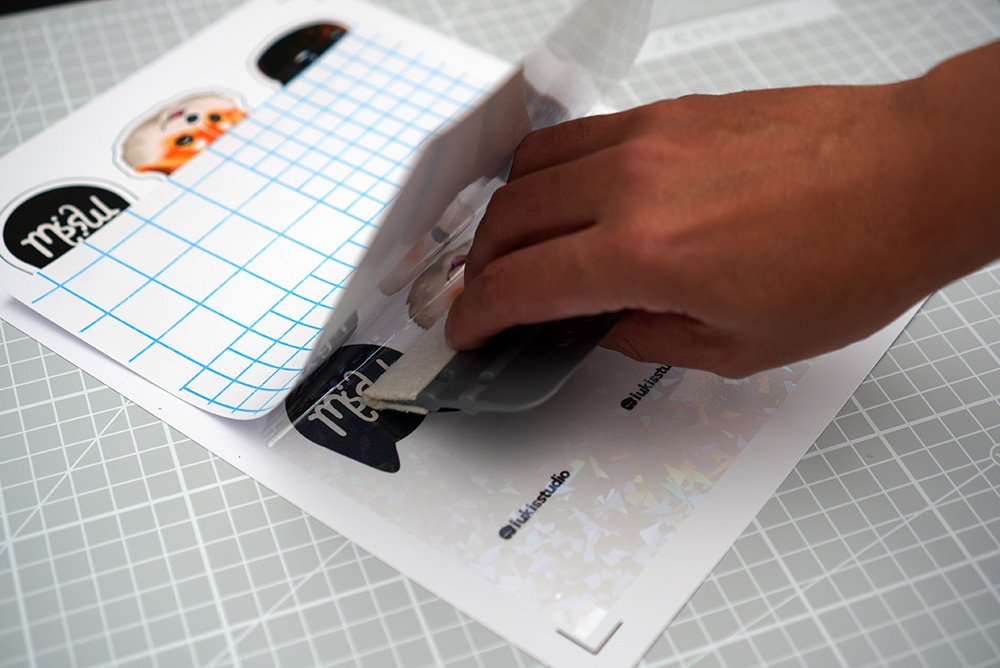 applying vinyl on bookmarks with squeegee