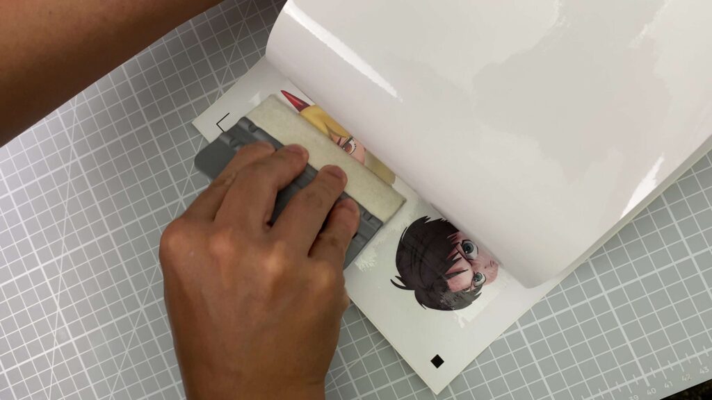 using a squeegee to laminate stickers